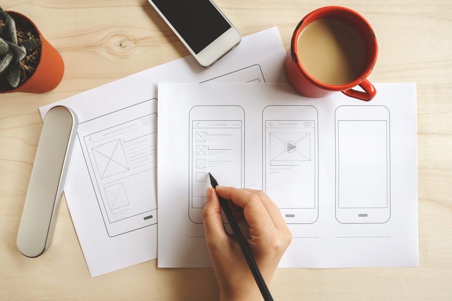 Sketching app screen layouts on paper